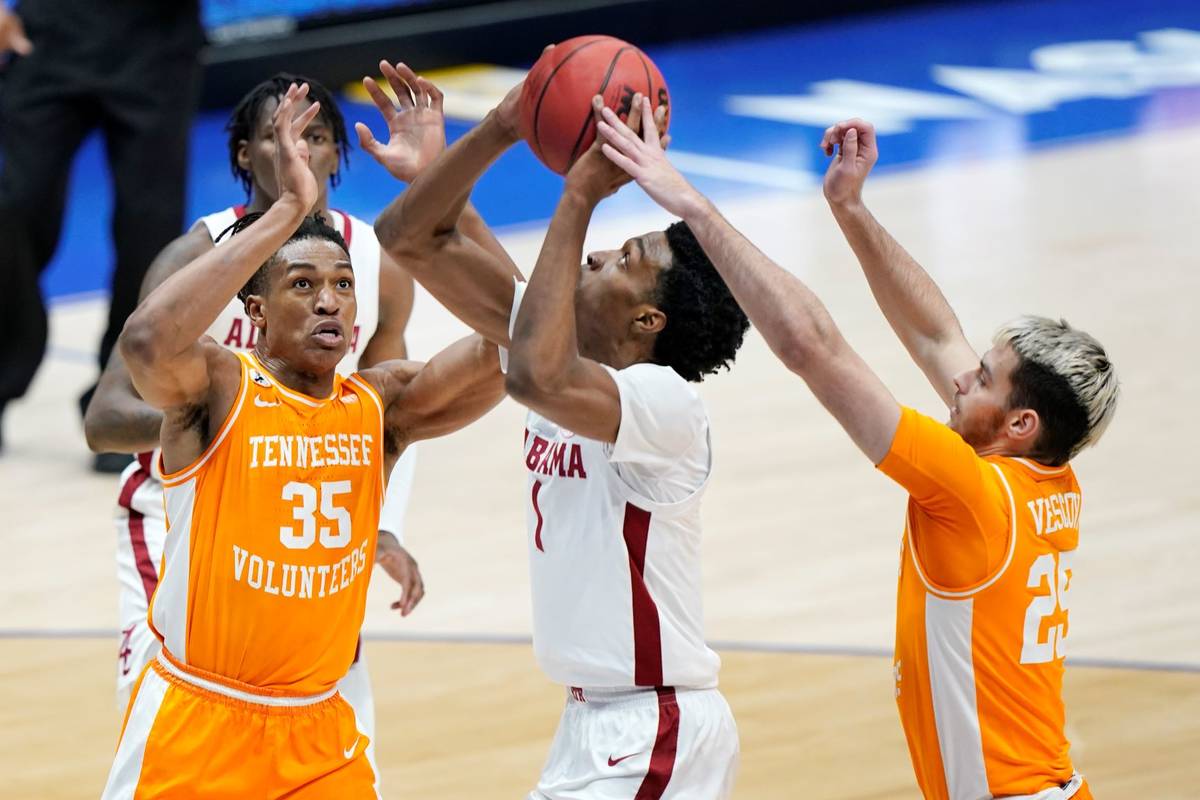 Alabama's Herbert Jones (1) is defended by Tennessee's Yves Pons (35) and Santiago Vescovi (25) ...