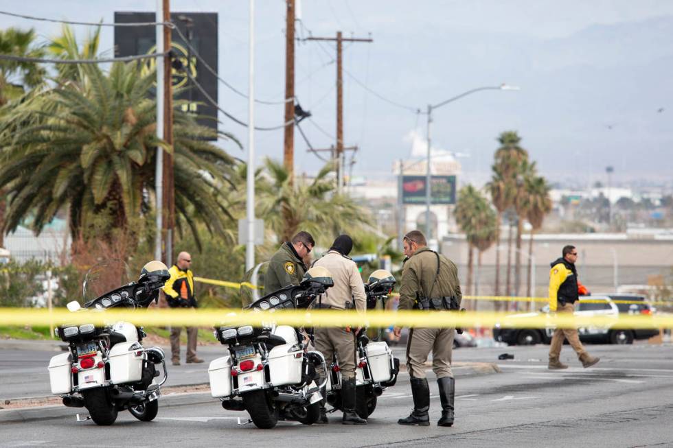 Metropolitan police investigate a crash involving two vehicles and a pedestrian at the intersec ...