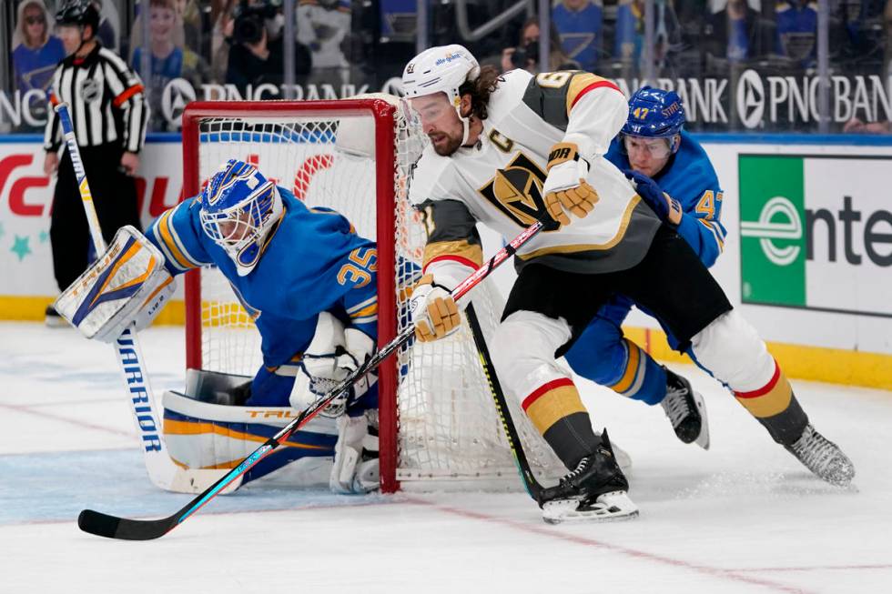 Vegas Golden Knights' Mark Stone, center, scores past St. Louis Blues goaltender Ville Husso, l ...