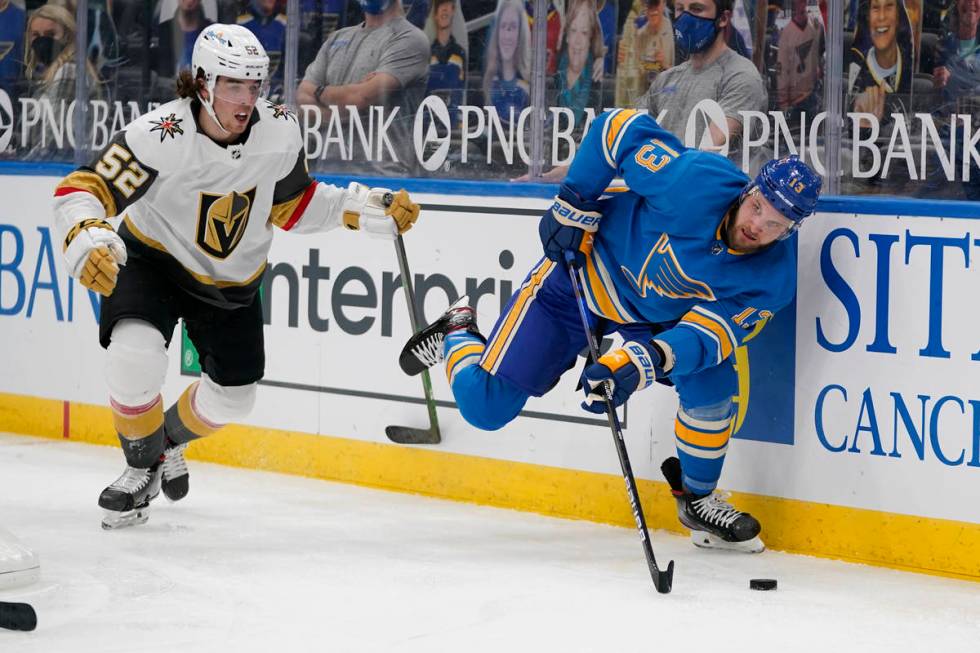 St. Louis Blues' Kyle Clifford (13) looks to pass as Vegas Golden Knights' Dylan Coghlan (52) d ...