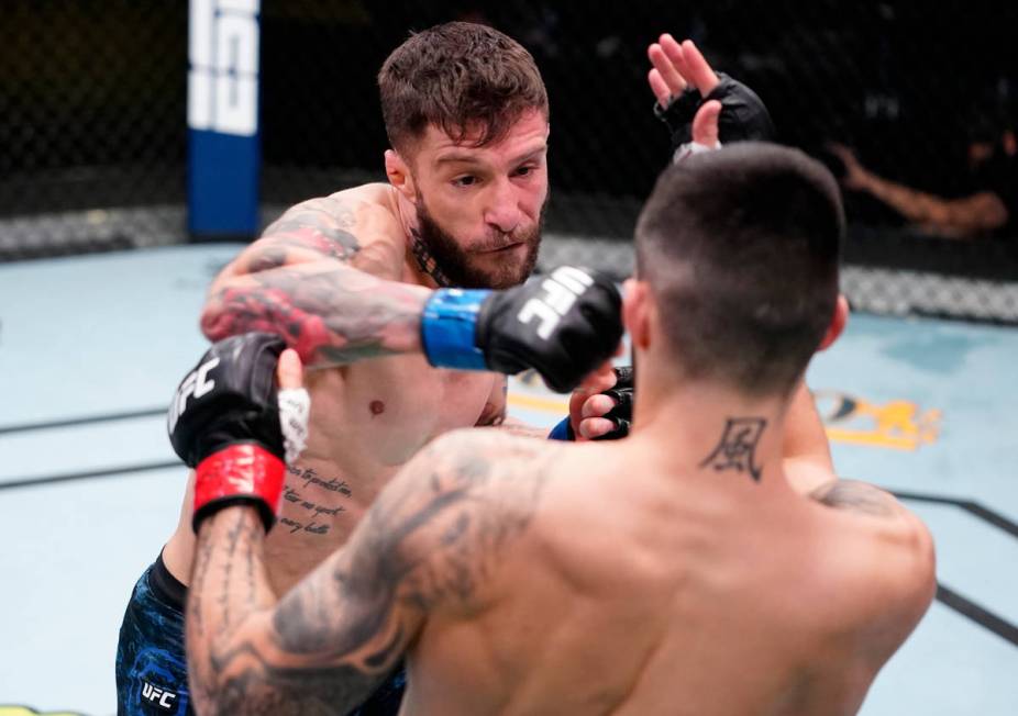 Marcelo Rojo of Argentina punches Charles Jourdain of Canada in a featherweight fight during th ...