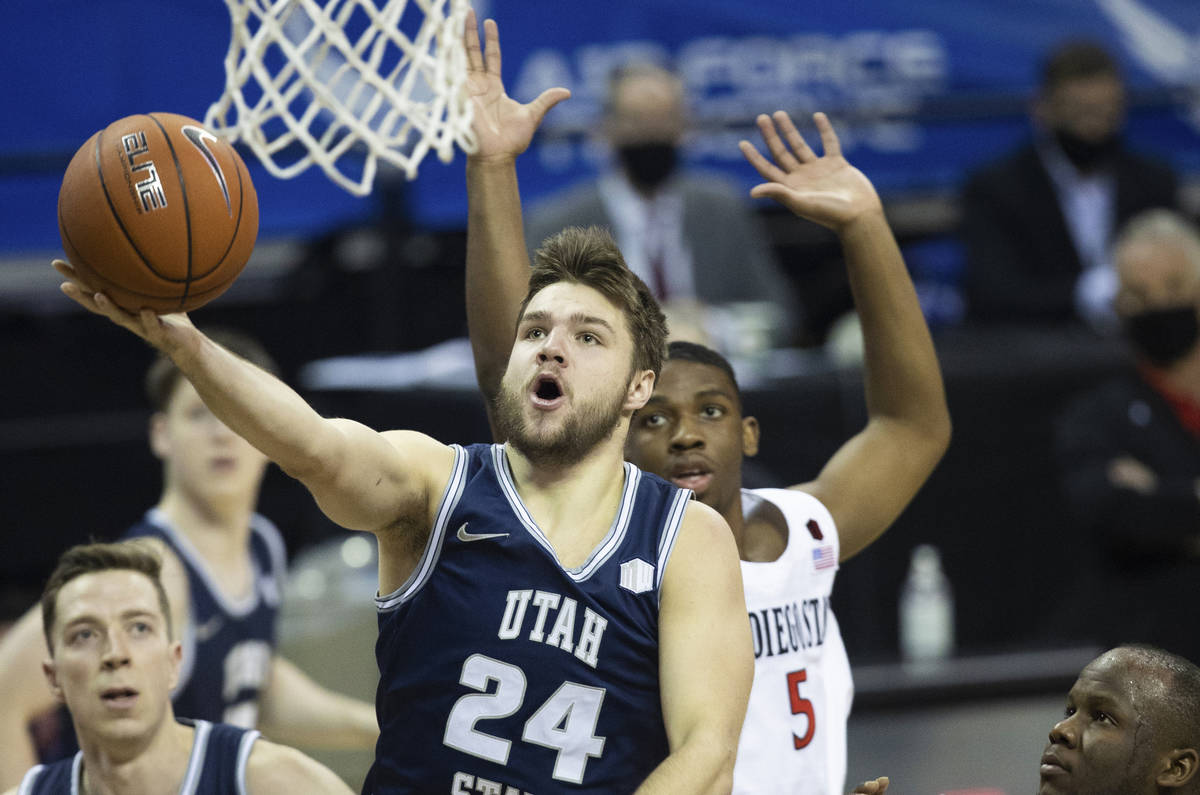 Utah State Aggies guard Rollie Worster (24) slashes to the rim past San Diego State Aztecs guar ...