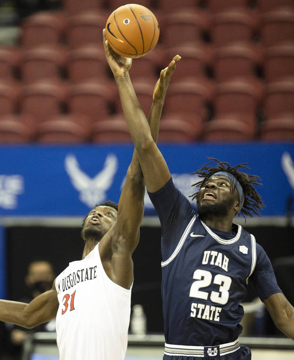 Utah State Aggies guard Karson Stastny (21) fights for a loose ball with San Diego State Aztecs ...