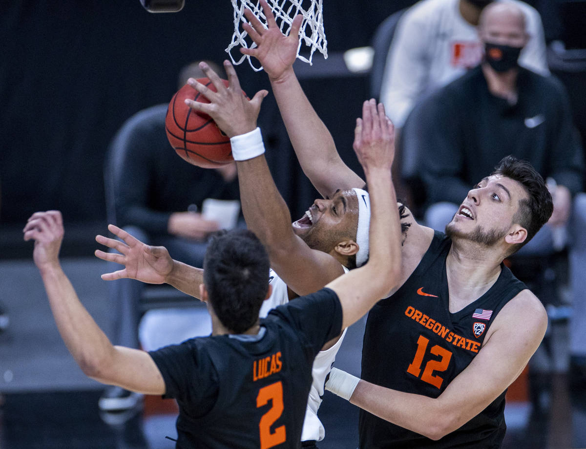 Colorado Buffaloes forward Evan Battey (21) battles under the net with Oregon State Beavers gua ...