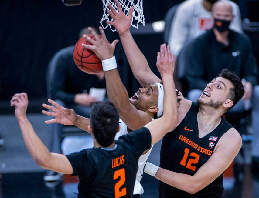 Colorado Buffaloes forward Evan Battey (21) battles under the net with Oregon State Beavers gua ...