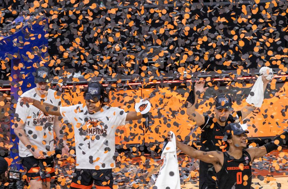 Oregon State Beavers players celebrate their win with confetti after defeating the Colorado Buf ...