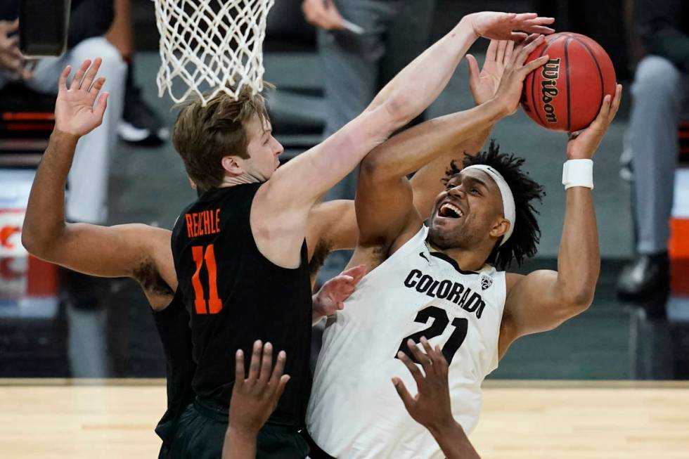 Colorado's Evan Battey (21) shoots around Oregon State's Zach Reichle (11) during the first hal ...