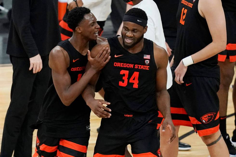 Oregon State's Warith Alatishe, left, and Rodrigue Andela (34) celebrate after defeating Oregon ...