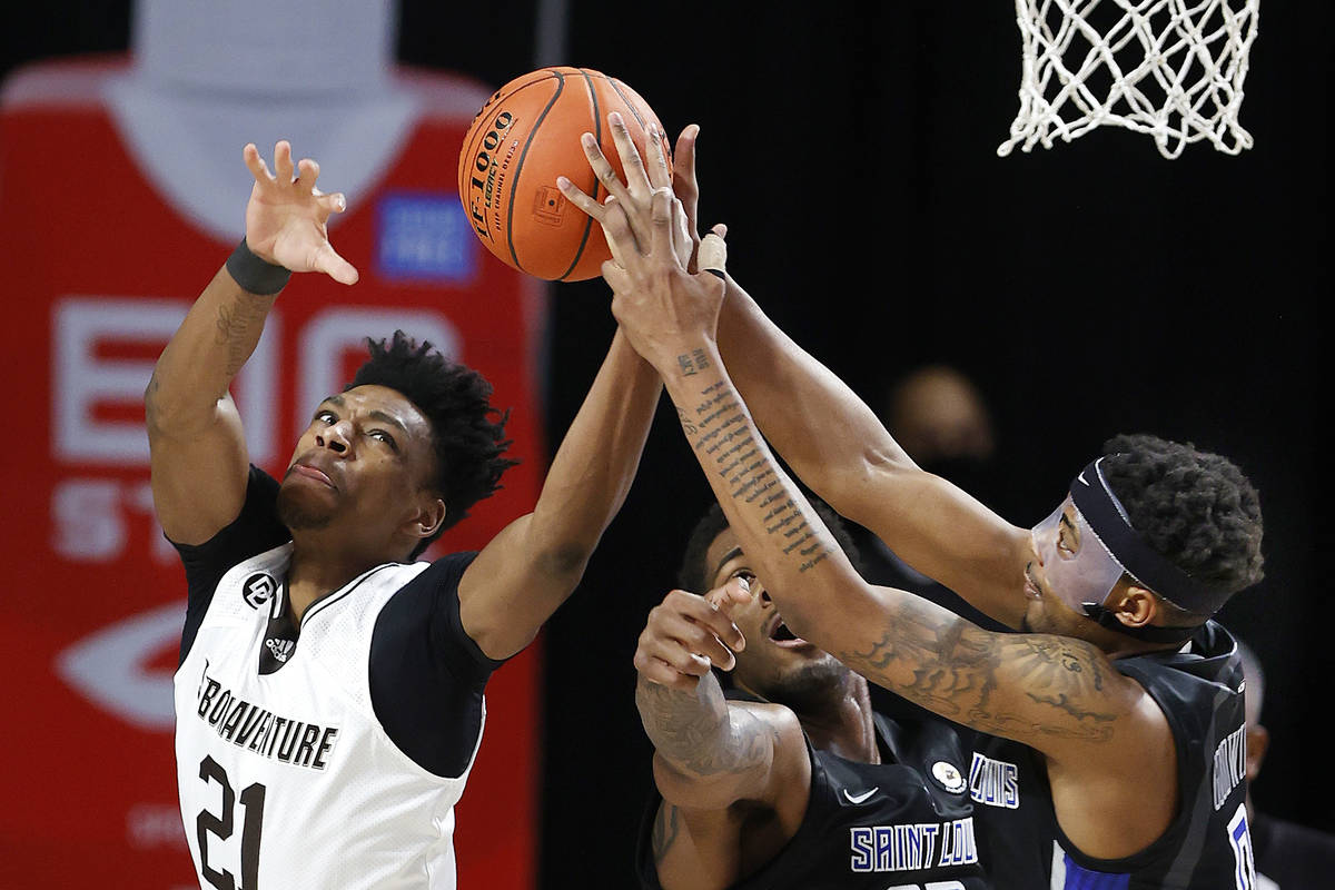 St. Bonaventure 's Osun Osunniyi, left, and Saint Louis' Jordan Goodwin vie for a rebound durin ...