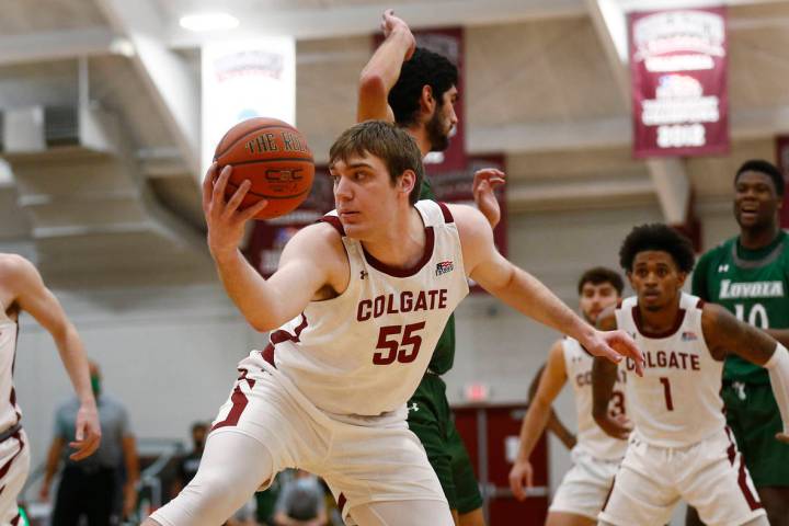 Colgate's Jeff Woodward (55) grabs a rebound against Loyola (Md.) during an NCAA college basket ...