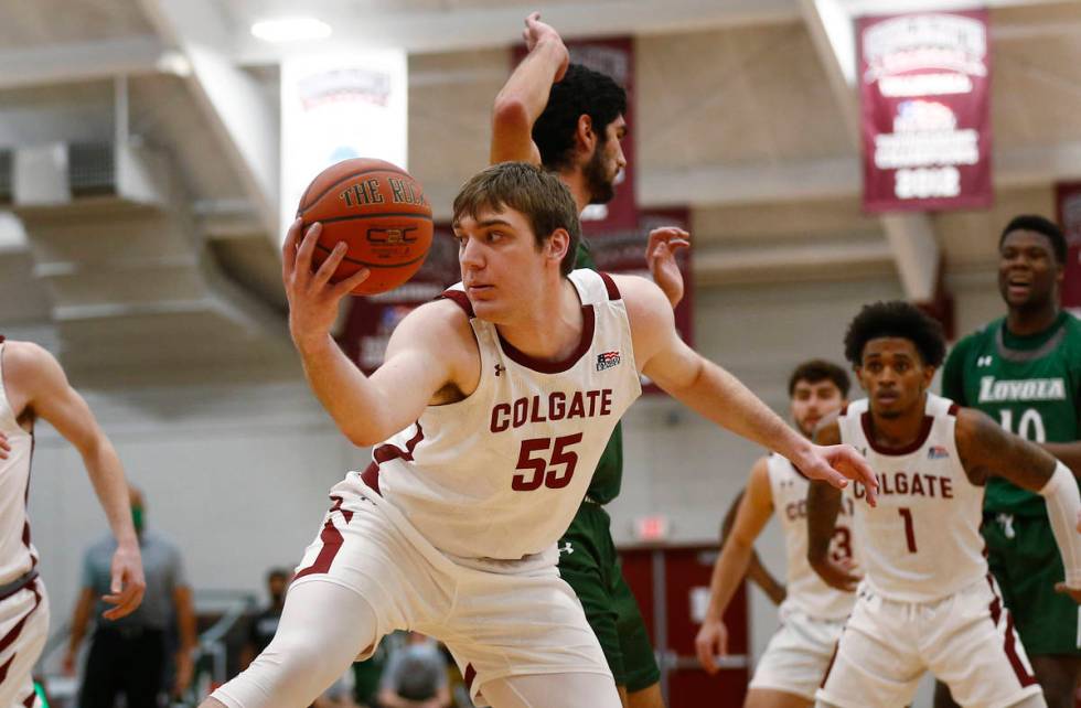 Colgate's Jeff Woodward (55) grabs a rebound against Loyola (Md.) during an NCAA college basket ...