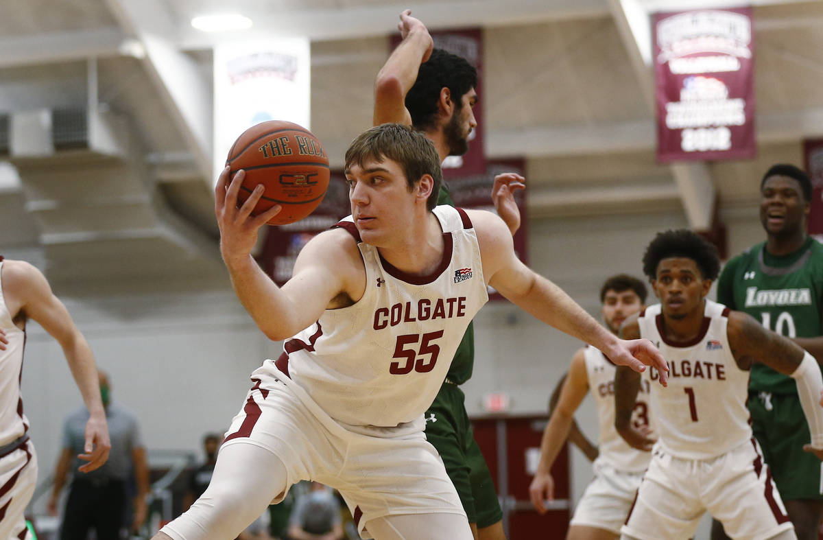 Colgate's Jeff Woodward (55) grabs a rebound against Loyola (Md.) during an NCAA college basket ...