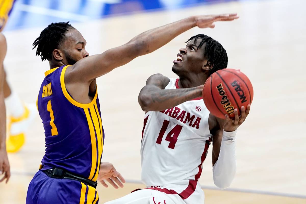 Alabama's Keon Ellis (14) drives against LSU's Ja'Vonte Smart (1) during the first half of the ...