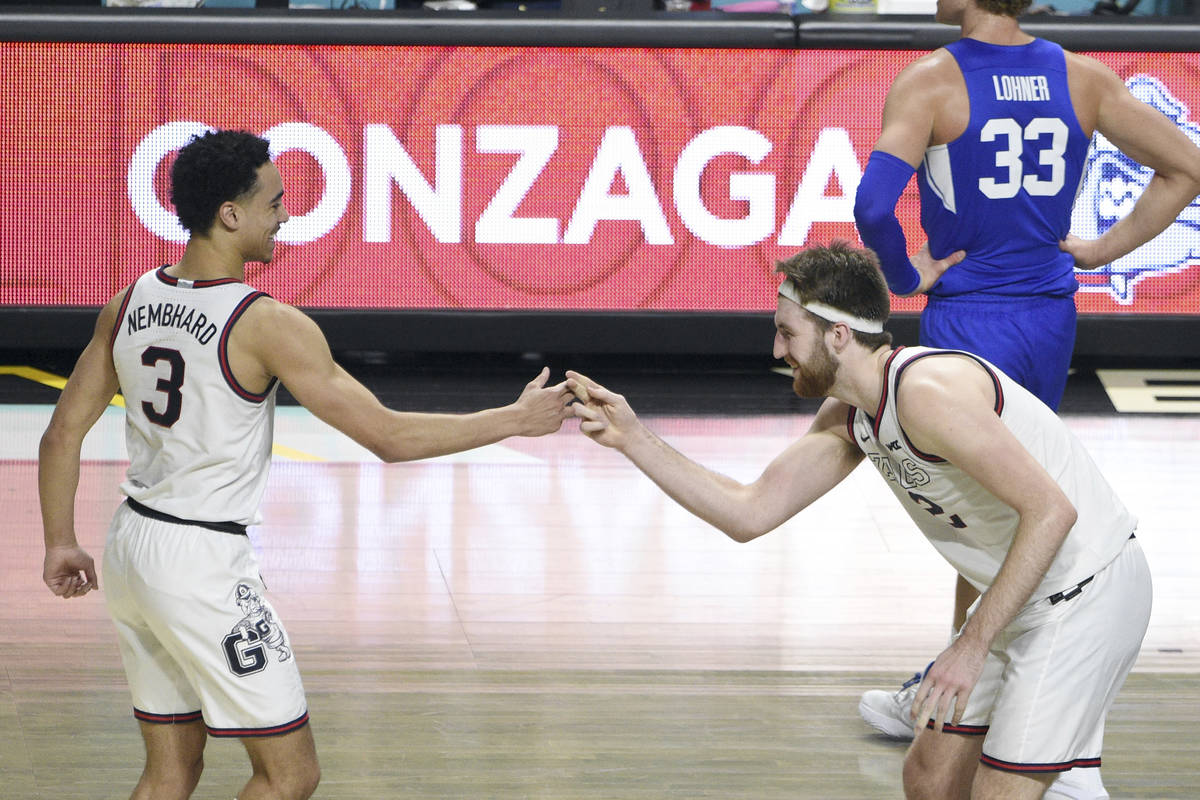 Gonzaga guard Andrew Nembhard (3) and forward Drew Timme (2) celebrate after they defeated BYU ...