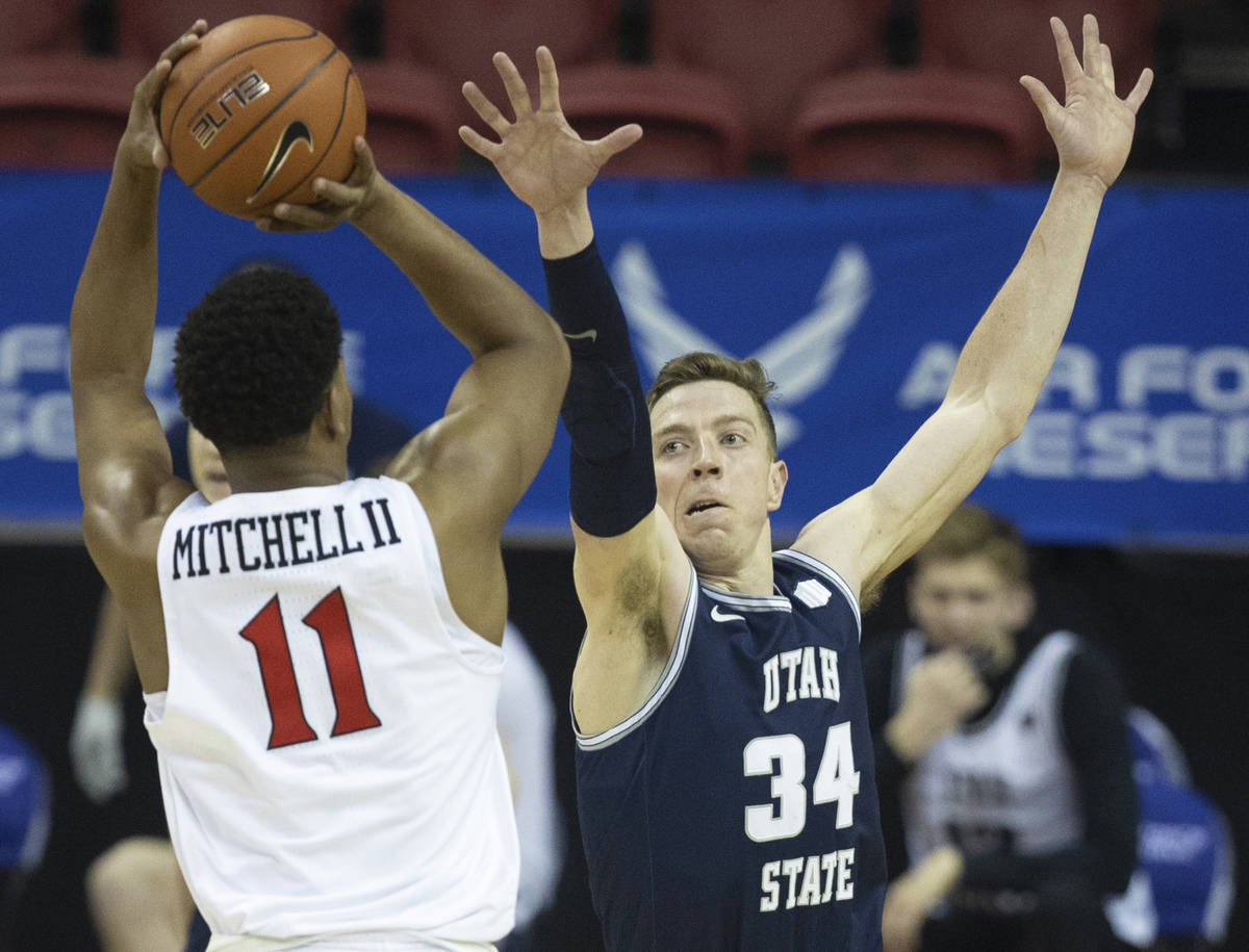 Utah State Aggies forward Justin Bean (34) contests the shot of San Diego State Aztecs forward ...