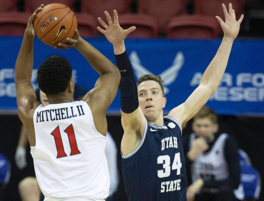 Utah State Aggies forward Justin Bean (34) contests the shot of San Diego State Aztecs forward ...