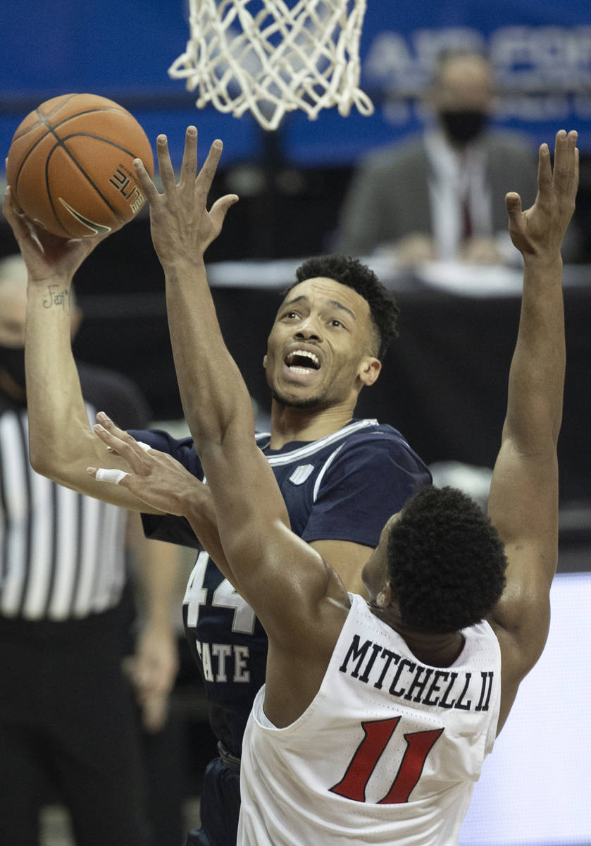 Utah State Aggies guard Marco Anthony (44) shoots over San Diego State Aztecs forward Matt Mitc ...