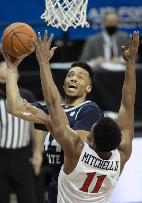 Utah State Aggies guard Marco Anthony (44) shoots over San Diego State Aztecs forward Matt Mitc ...