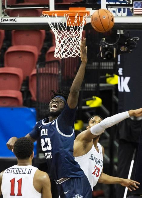 Utah State Aggies center Neemias Queta (23) fights for a loose ball with San Diego State Aztecs ...