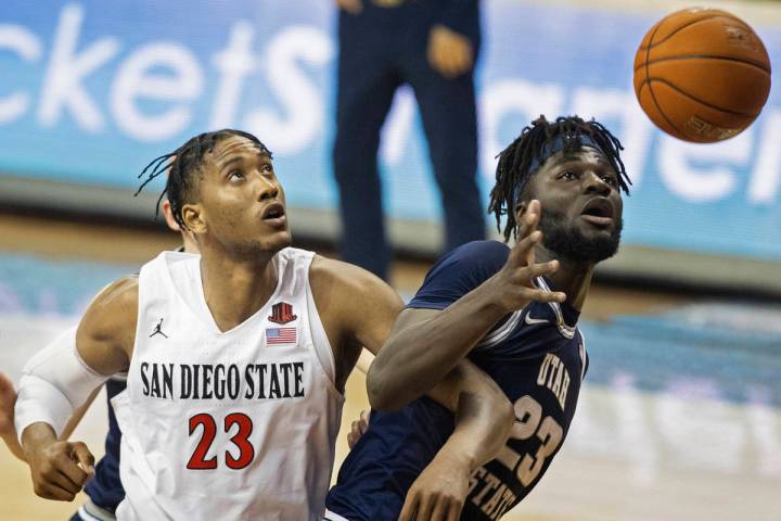 San Diego State Aztecs forward Joshua Tomaic (23) fights for a loose ball with Utah State Aggie ...