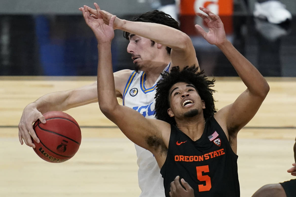 UCLA's Jaime Jaquez Jr., left, fouls Oregon State's Ethan Thompson (5) during the second half o ...