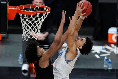 Oregon State's Ethan Thompson, left, fouls UCLA's Jules Bernard during the second half of an NC ...