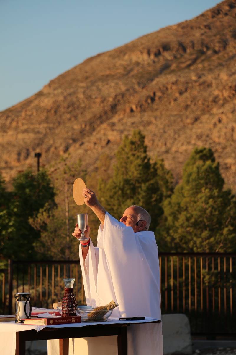 With nature as a backdrop, the Rev. William Kenny of Holy Spirit Catholic Church celebrates a p ...