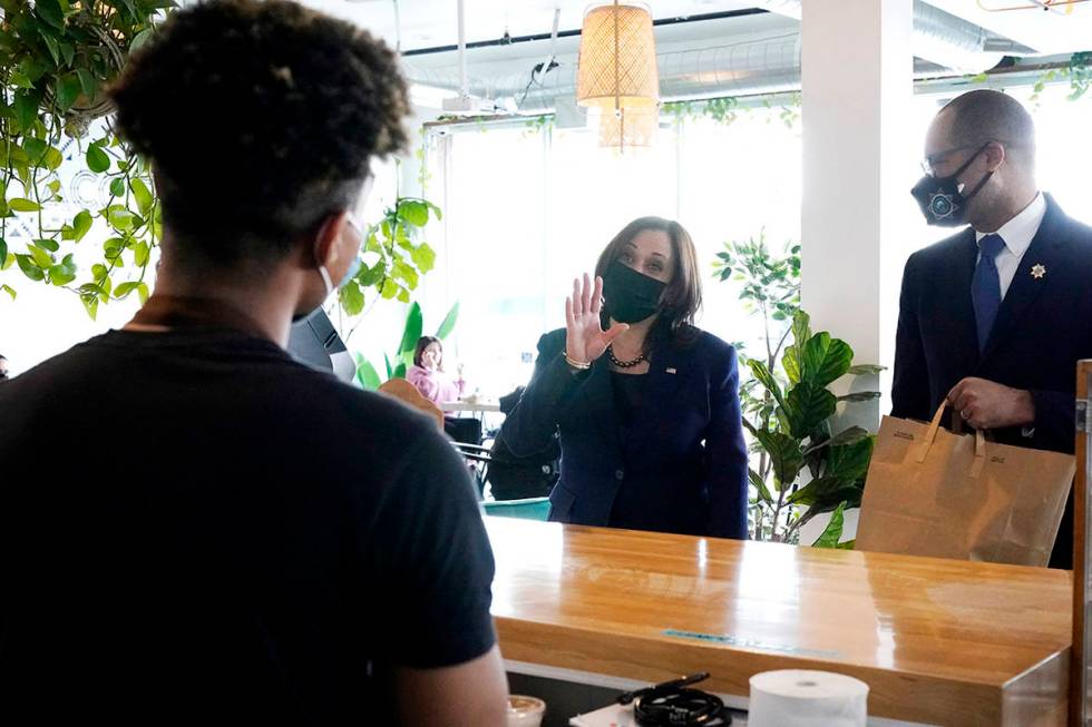 Vice President Kamala Harris, right, talks to employees while stopping for lunch at Tacotarian, ...