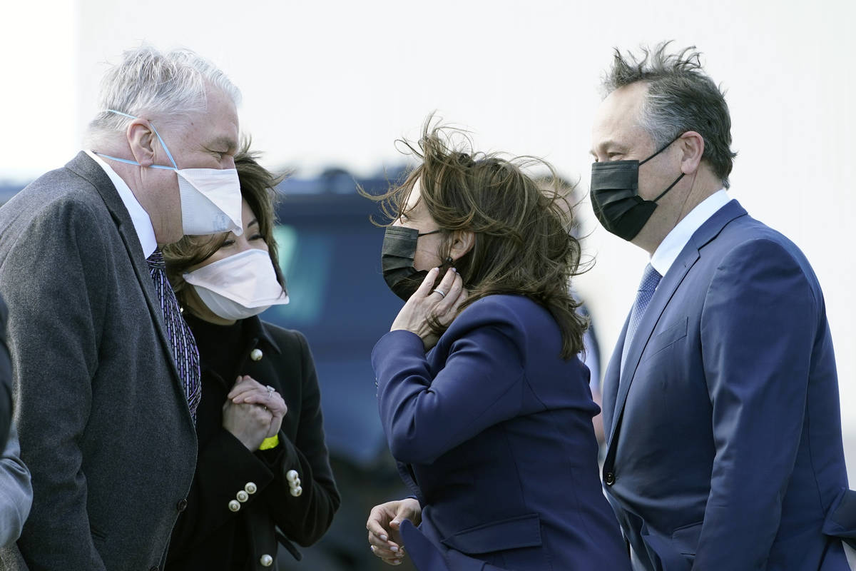 Vice President Kamala Harris and her husband, Doug Emhoff, are greeted by Nevada Gov. Steve Sis ...