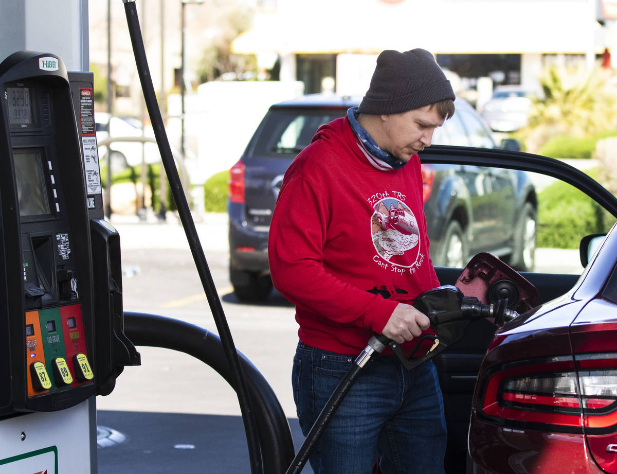 Brandon Edester pumps gas at Costco, on Monday, March, 15, 2021, in Las Vegas. (Bizuayehu Tesfa ...