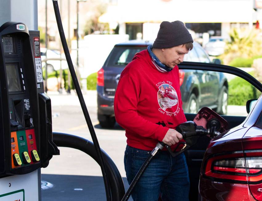 Brandon Edester pumps gas at Costco, on Monday, March, 15, 2021, in Las Vegas. (Bizuayehu Tesfa ...