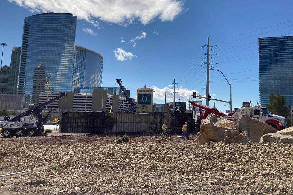 Crews work on an overturned semitractor-trailer Monday, March 15, 2021, on the eastbound Flamin ...