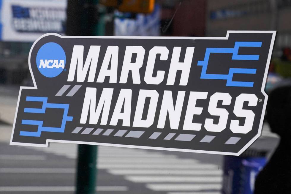 A March Madness sticker for the NCAA college basketball tournament is placed on a window in dow ...