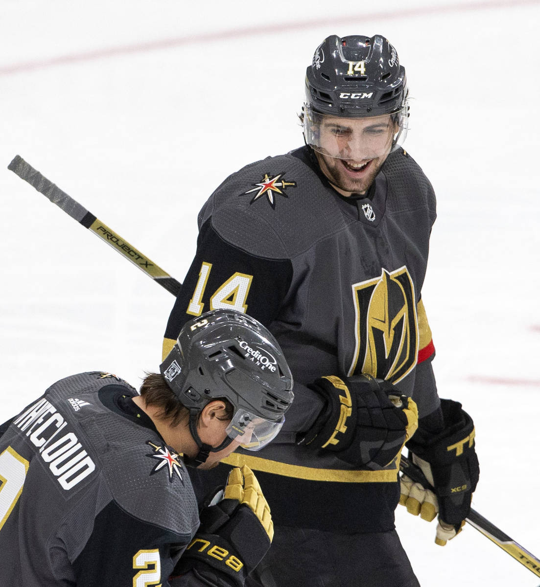 Golden Knights' defenseman Nicolas Hague (14) celebrates with defenseman Zach Whitecloud (2) af ...