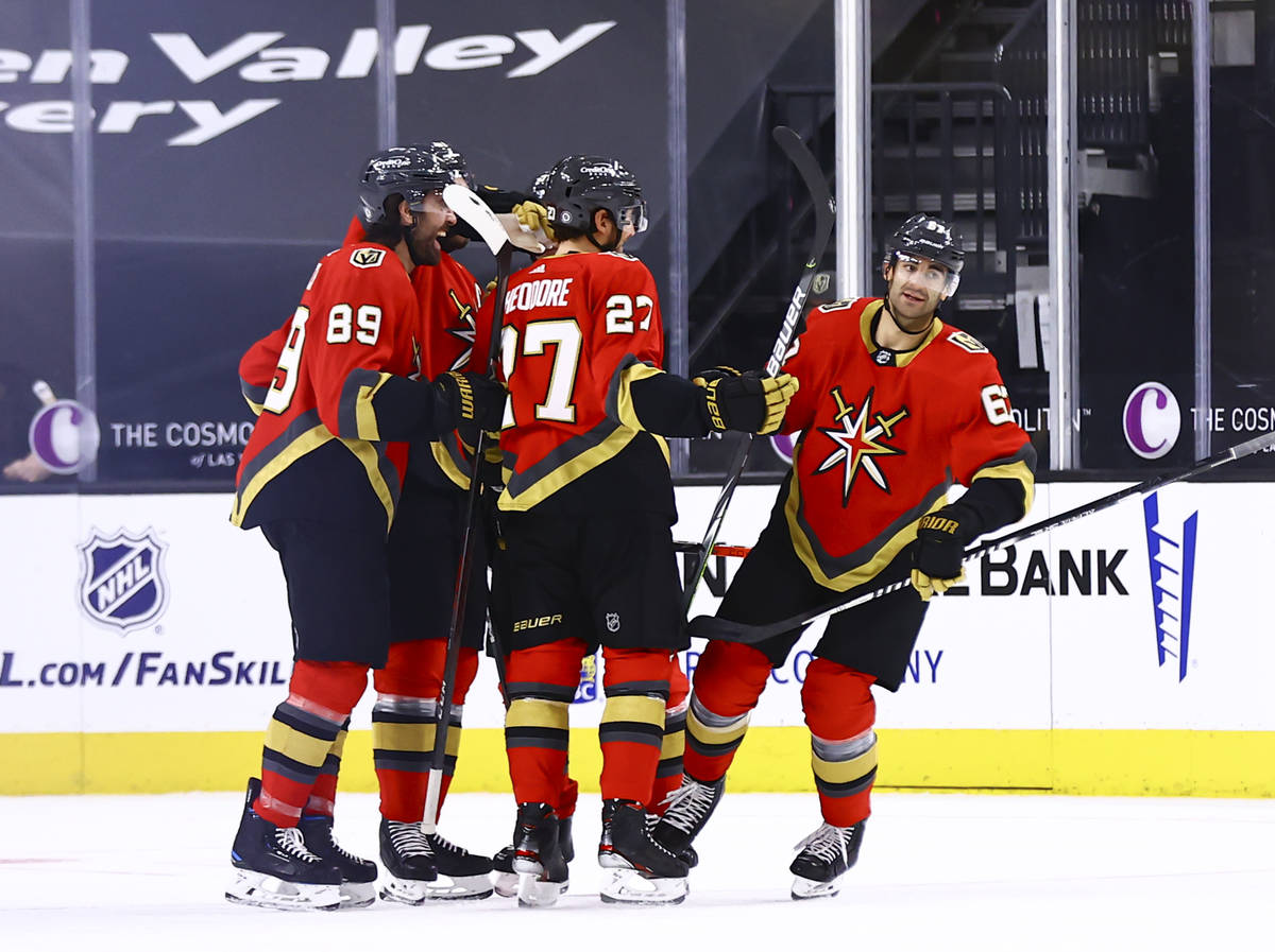 The Golden Knights celebrate after a goal by Max Pacioretty, right, during the first period of ...