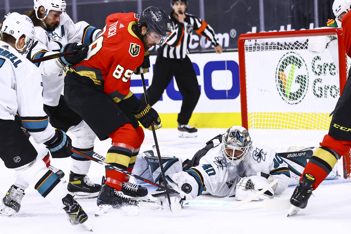 San Jose Sharks goaltender Devan Dubnyk reaches out for the puck against Golden Knights' Alex ...