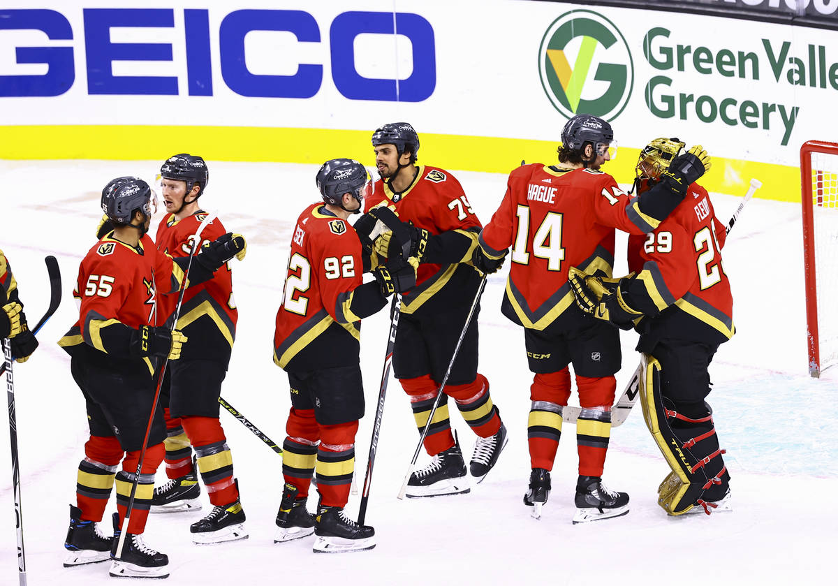 The Golden Knights celebrate with goaltender Marc-Andre Fleury, right, after defeating the San ...