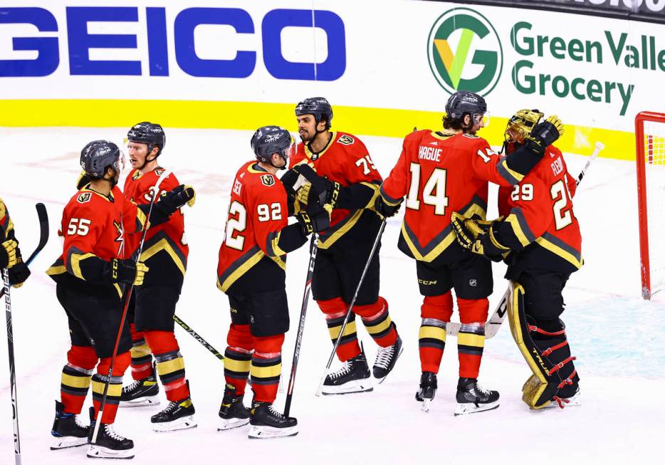 The Golden Knights celebrate with goaltender Marc-Andre Fleury, right, after defeating the San ...