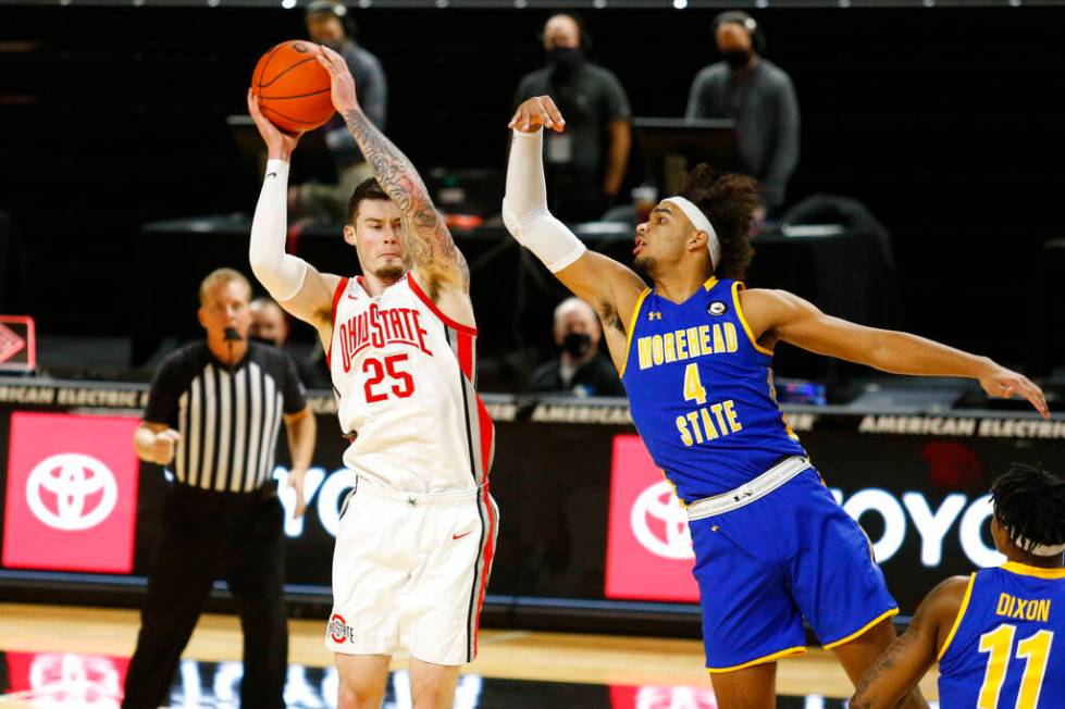 Ohio State forward Kyle Young, left, grabs a rebound against Morehead State forward Johni Broom ...