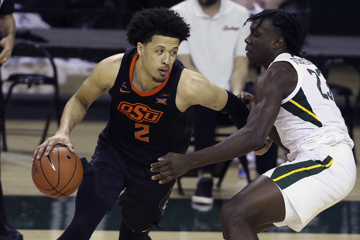 Oklahoma State guard Cade Cunningham (2) drives the ball against Baylor forward Jonathan Tchamw ...