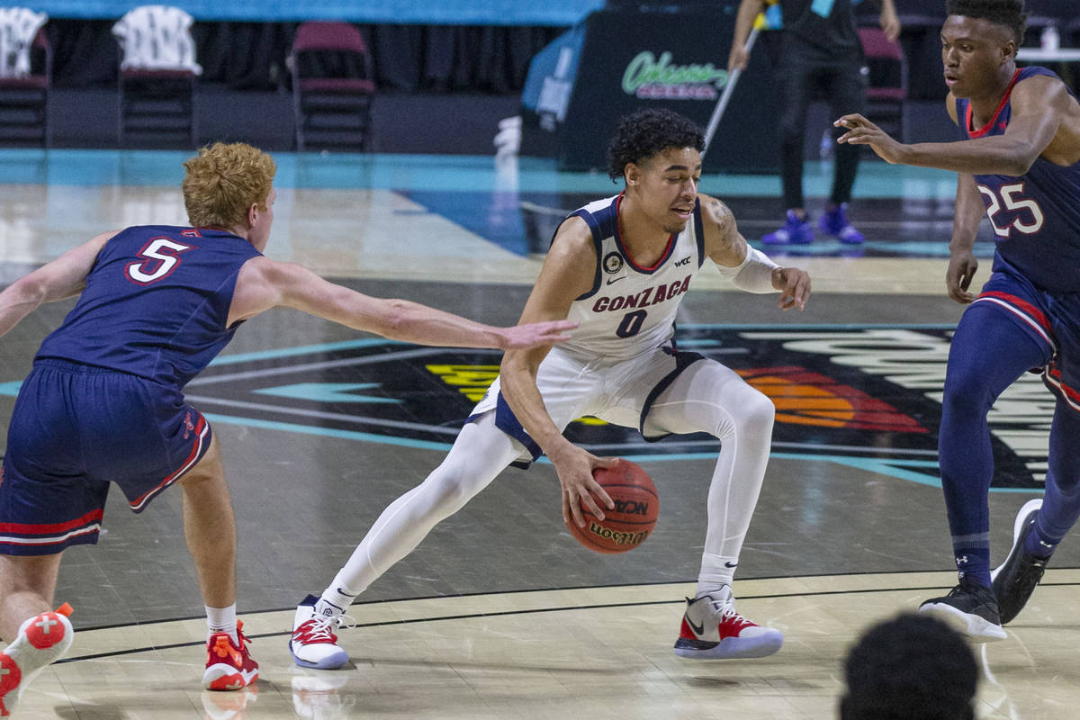 Gonzaga Bulldogs guard Julian Strawther (0) dribbles past St. Mary's Gaels guard Jabe Mullins ( ...