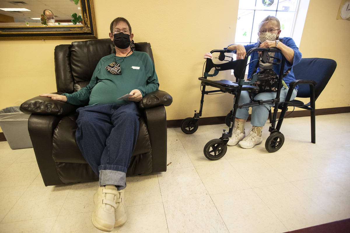 Cheryl Ray, 72, right, waits with her son Michael, 47, after he received the second dose of the ...