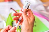 A nurse draws up the Moderna COVID-19 vaccine during a vaccination clinic that was run by the V ...