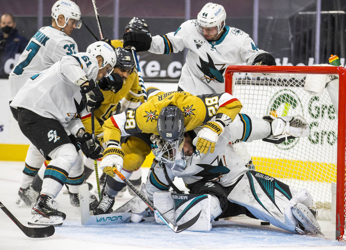 Golden Knights left wing William Carrier (28) gets over the top of San Jose Sharks goaltender D ...