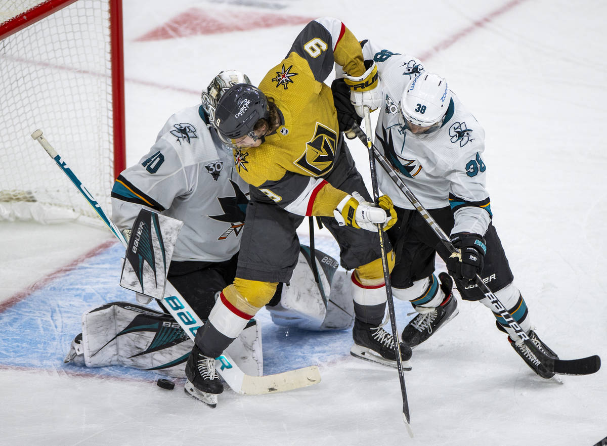 Golden Knights center Cody Glass (9) looks to get the puck into the net past San Jose Sharks go ...