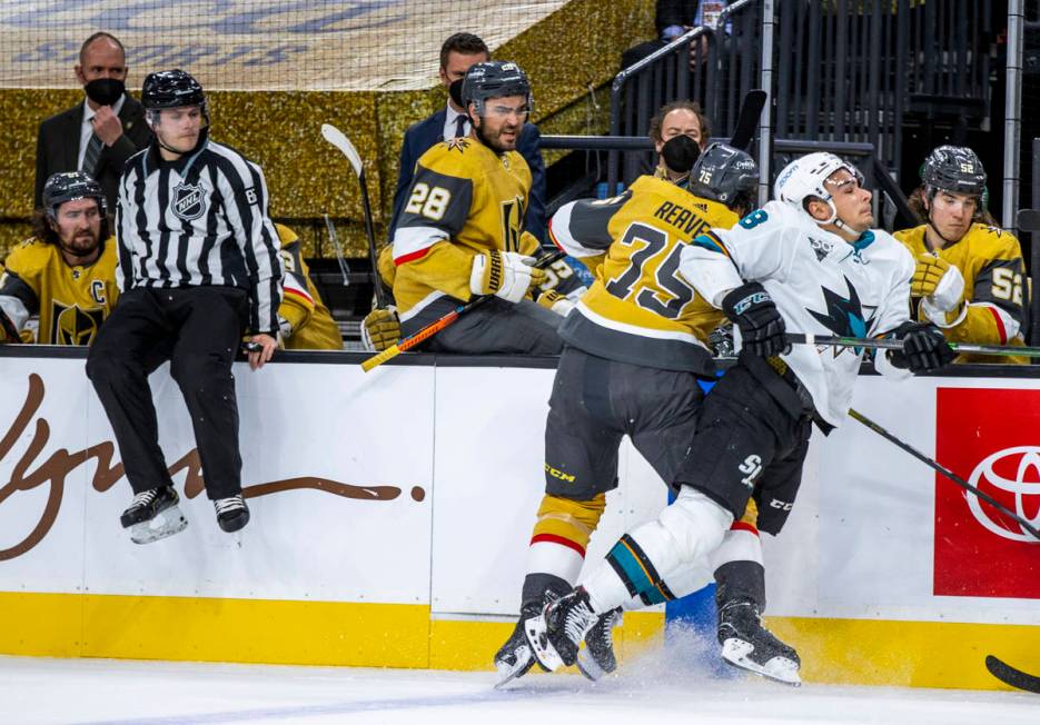 Golden Knights right wing Ryan Reaves (75) checks San Jose Sharks right wing Timo Meier (28) ha ...