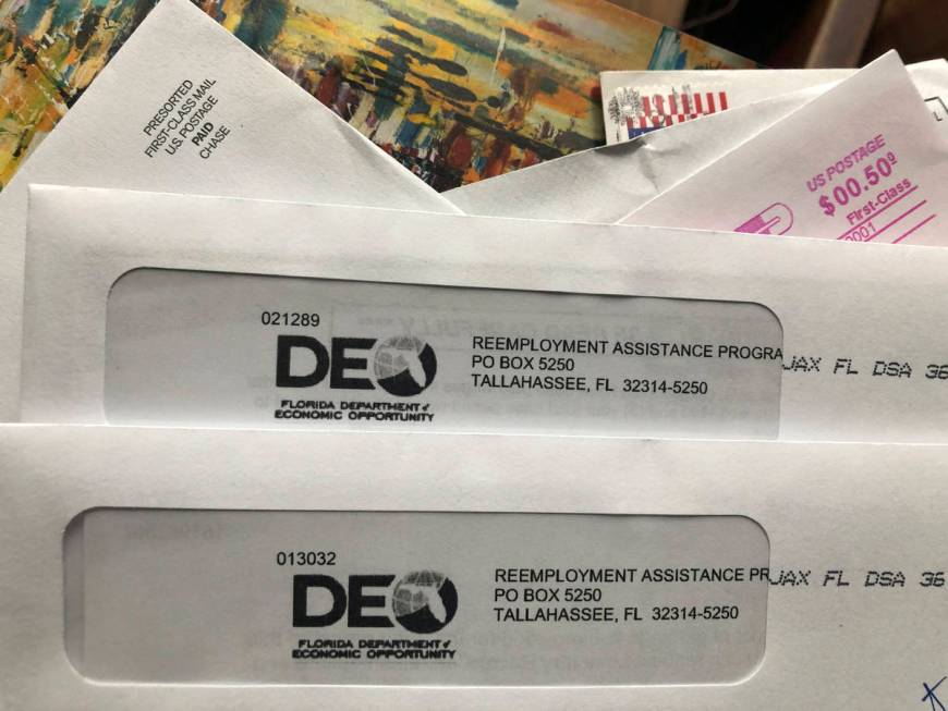 In this Thursday, Nov. 5, 2020, file photo, envelopes from the Florida Department of Economic O ...