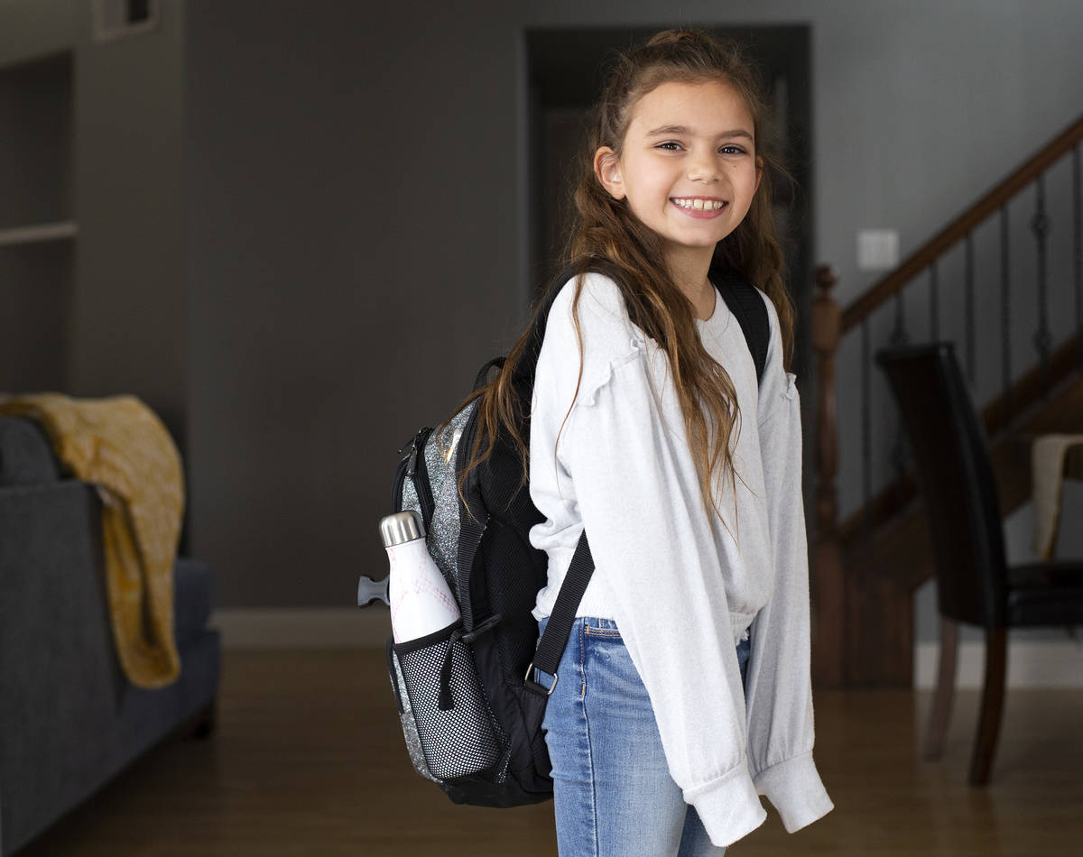 Third grader Sydney Hemberger poses for a portrait in her home after returning from school on T ...