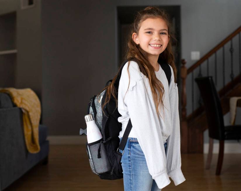 Third grader Sydney Hemberger poses for a portrait in her home after returning from school on T ...