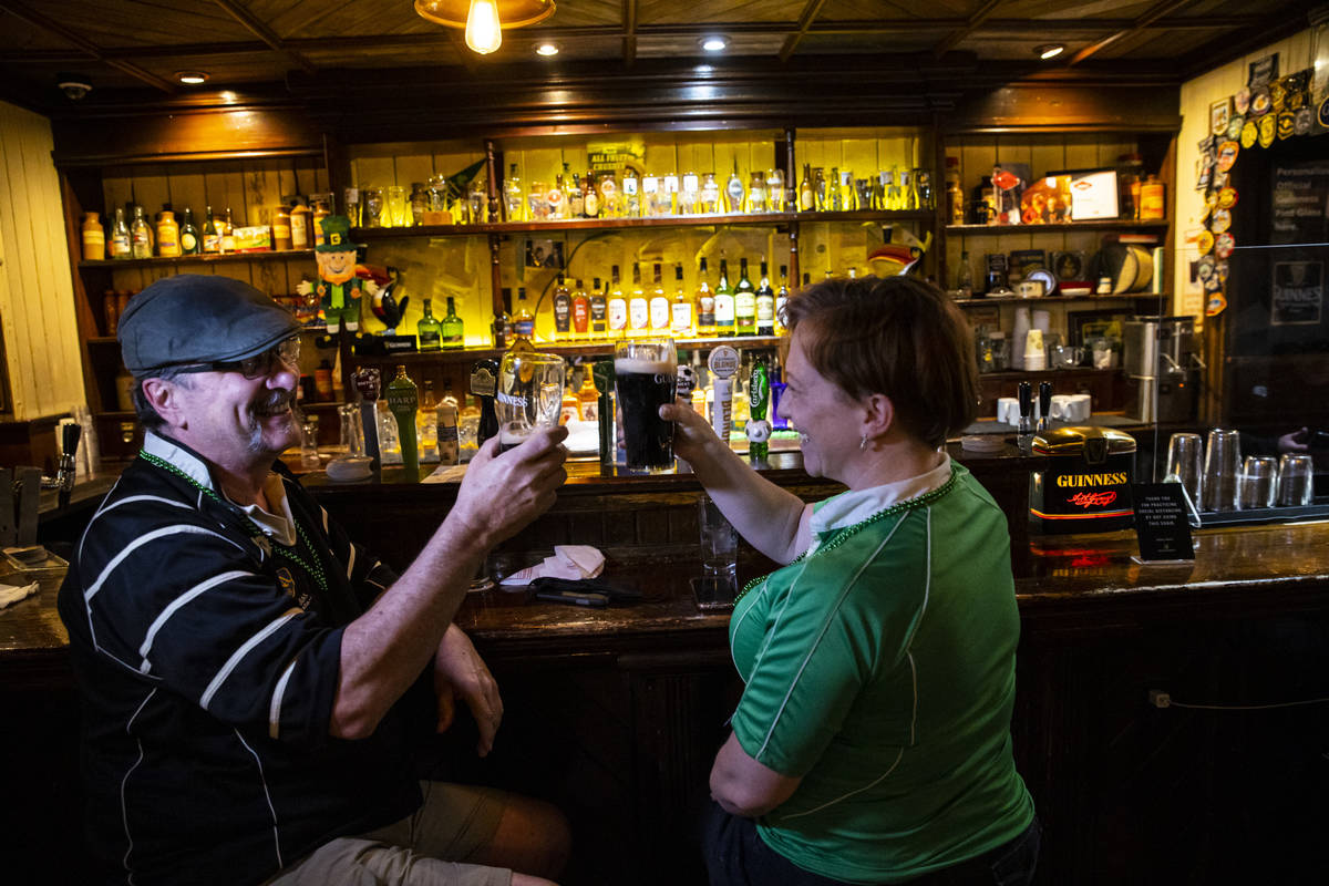 Arthur McFarland, left, and Kim McFarland toast as people gather to celebrate St. Patrick's Day ...